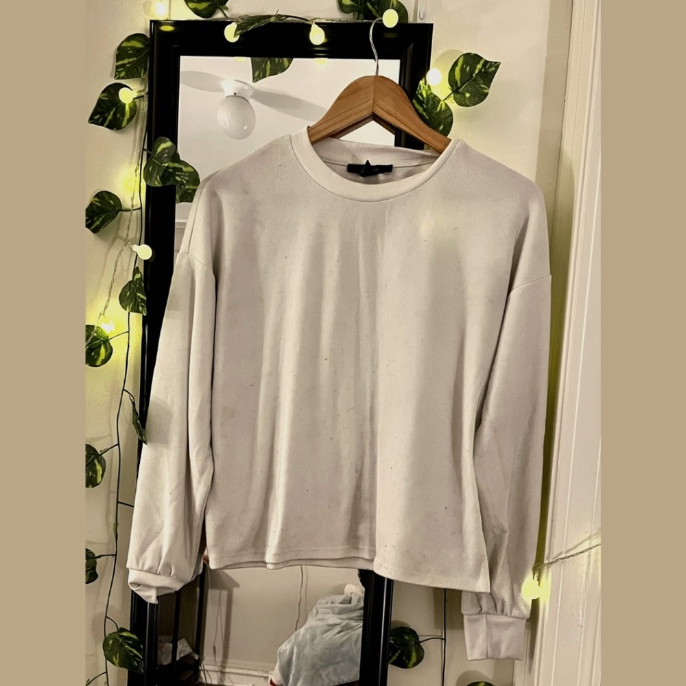 White long-sleeved laid-back top.